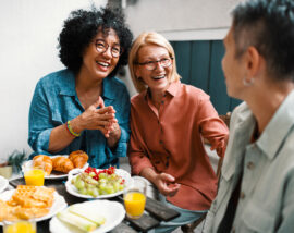 Happy Female Friends in Midlife Enjoying Food and Conversation