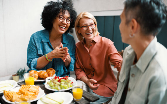 Happy Female Friends in Midlife Enjoying Food and Conversation