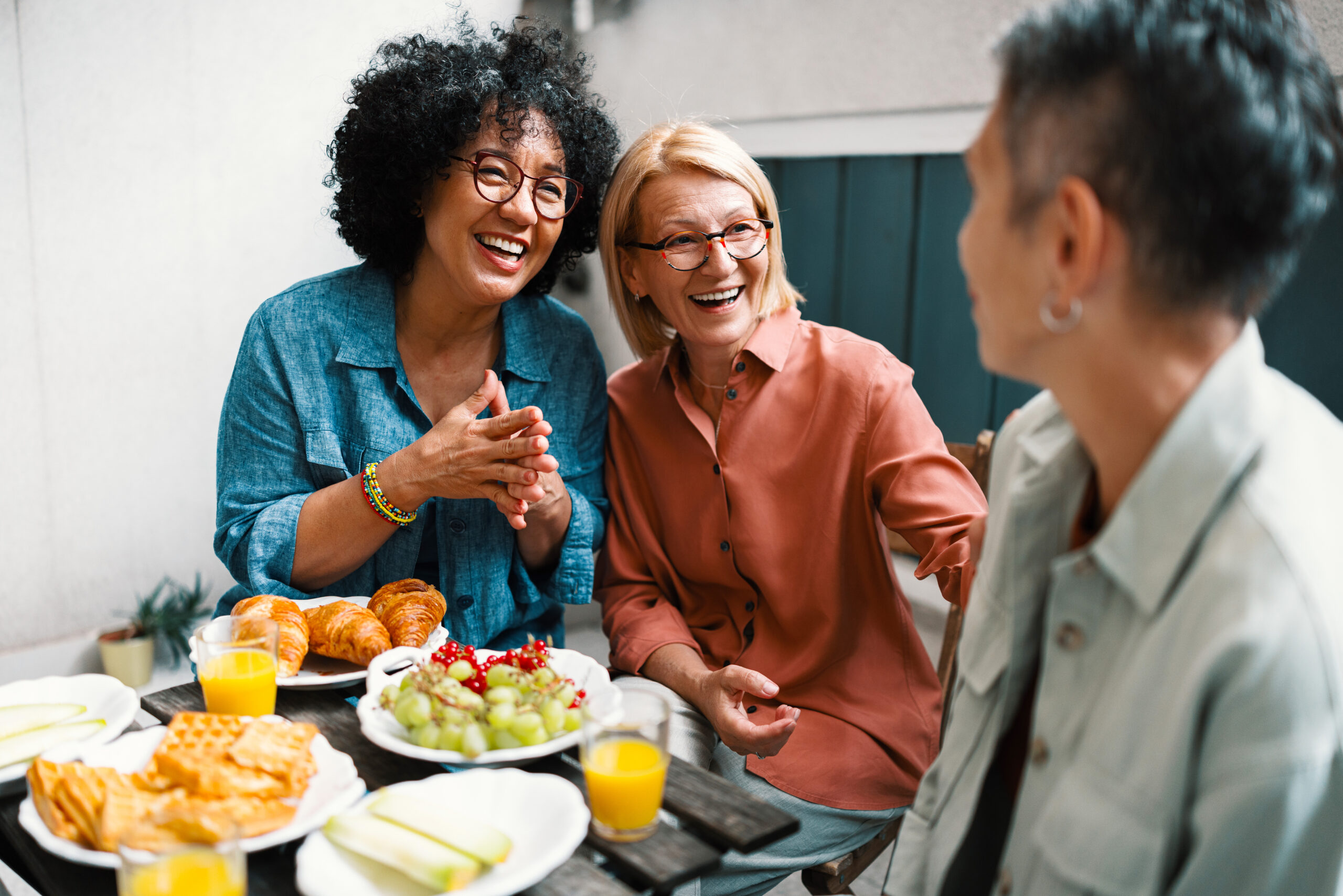 Happy Female Friends in Midlife Enjoying Food and Conversation
