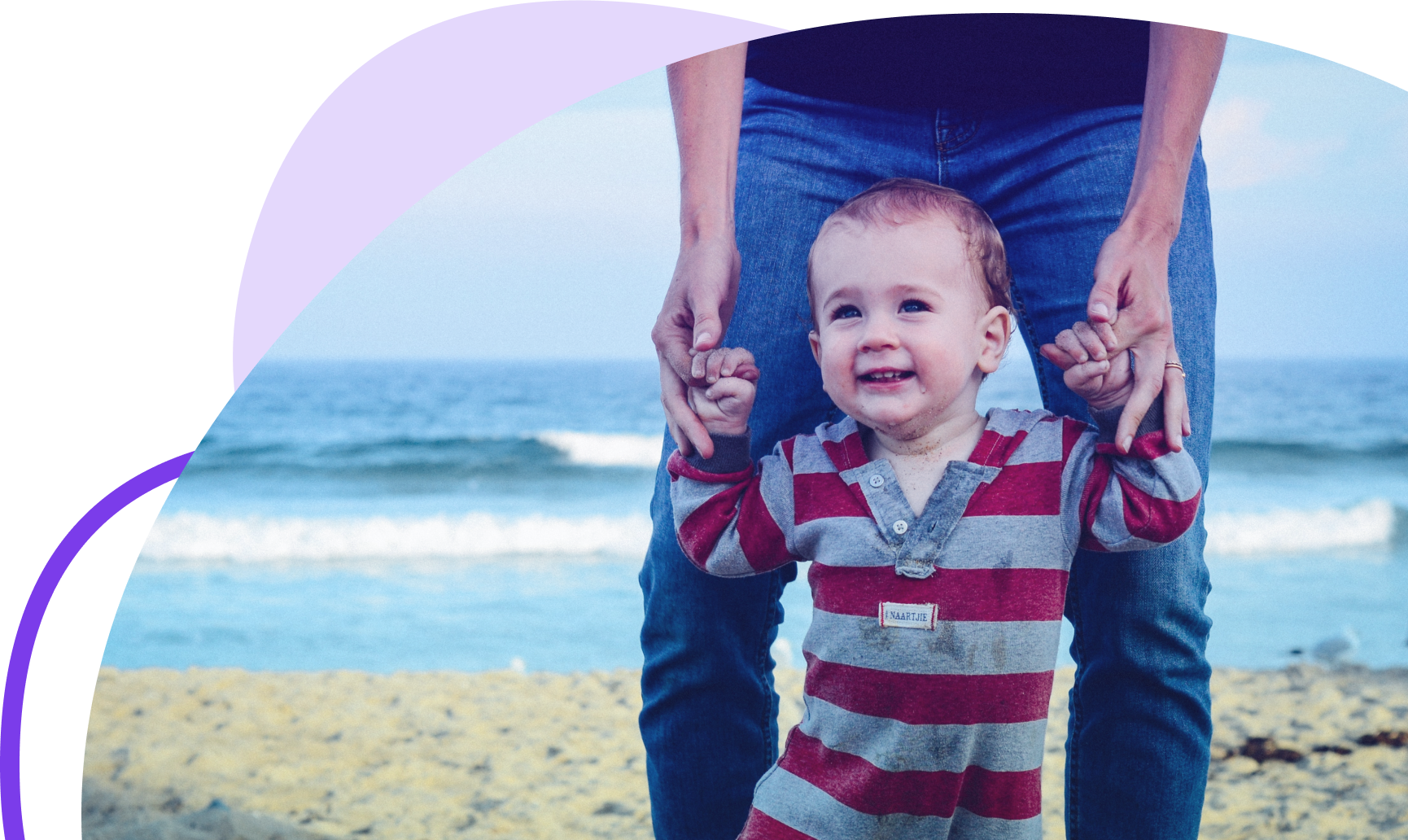 Baby being walked on beach