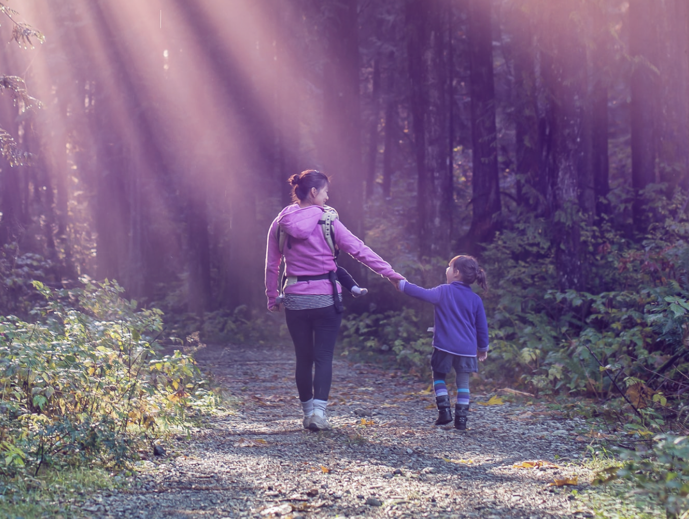 Mother and daughter walking in woods