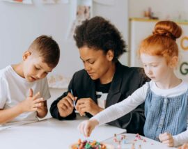 Adult and children playing with PlayDoh