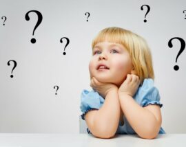 child surrounded by questionmarks