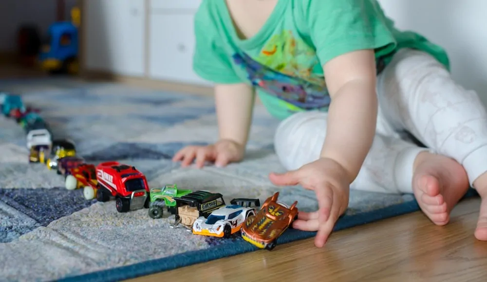 Child lining up cars