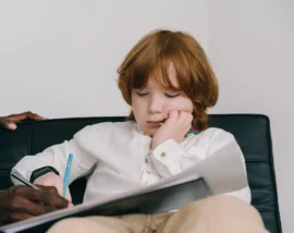 Bored looking child writing