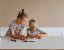 Girl helping boy with homework