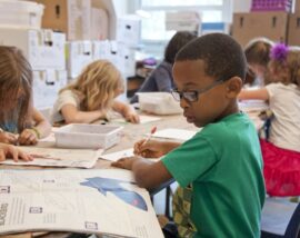 Boy completing school work in class