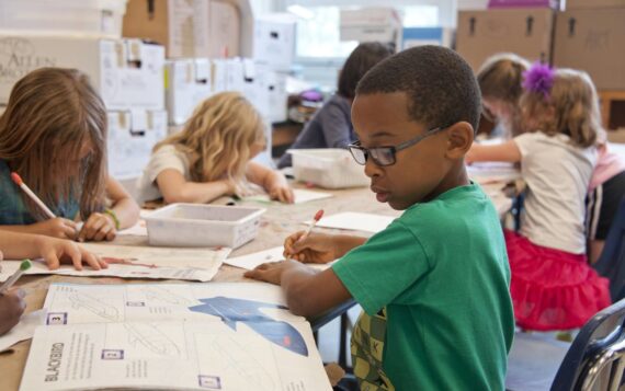 Boy completing school work in class